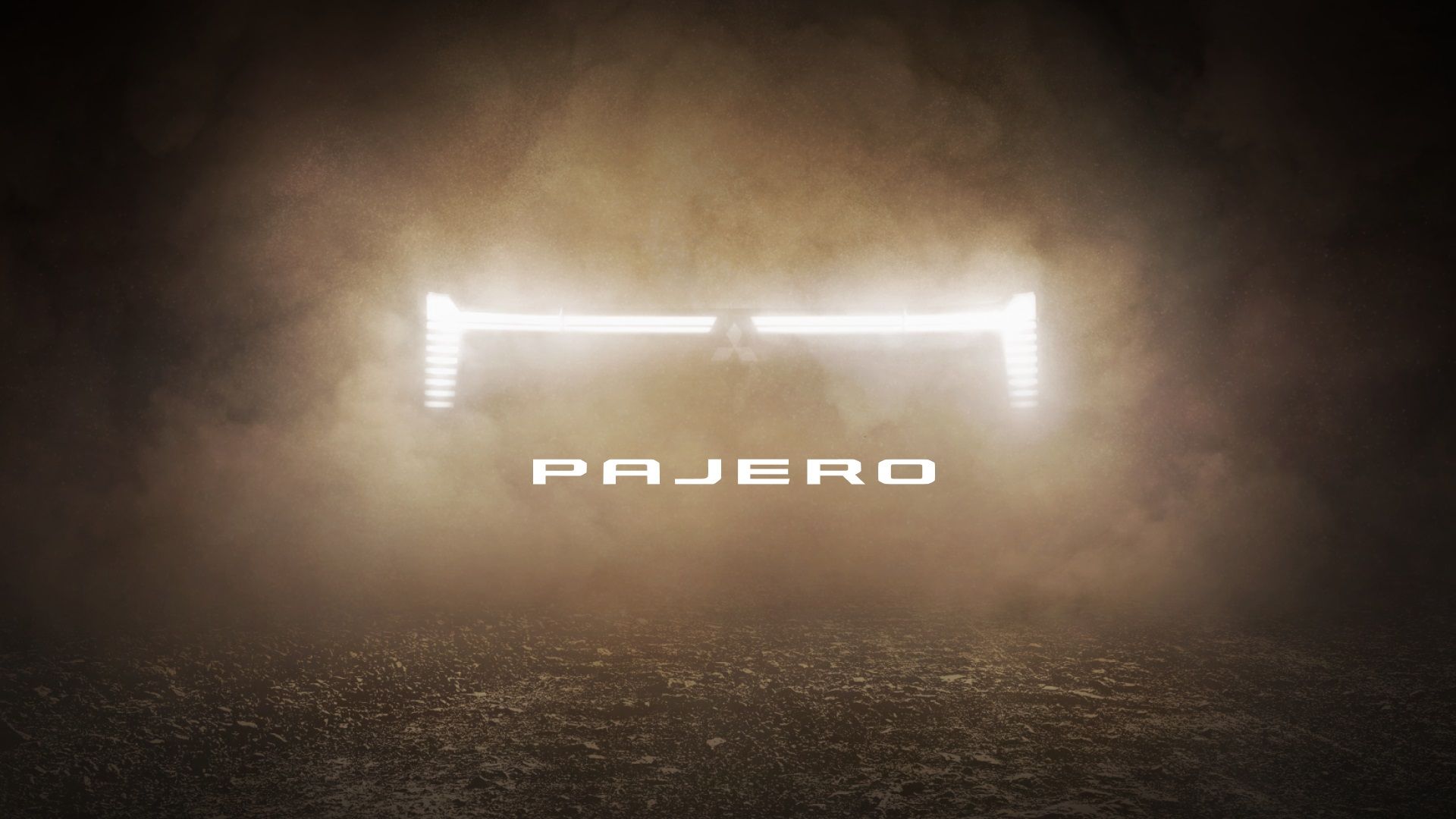 Mitsubishi Pajero 2026 — teaser premierowy: sygnatura świateł przednich w kłębach pyłu i dymu