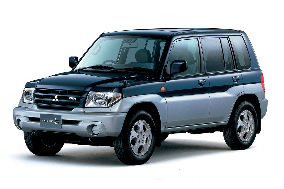 Mitsubishi Pajero iO GDI — przód 3/4, nadwozie dwukolorowe granatowo-srebrne, tło studyjne